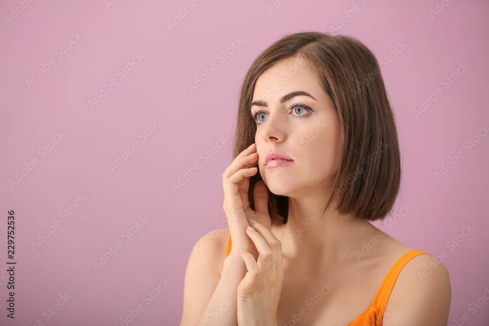 Fototapeta premium Portrait of beautiful young woman on color background