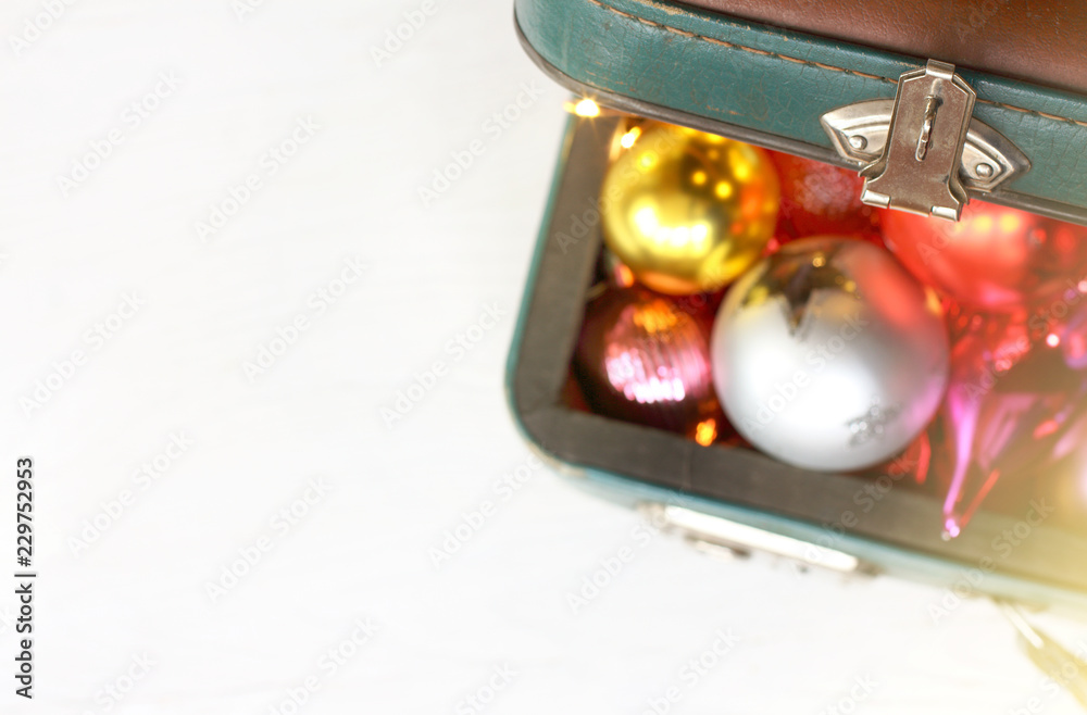 Christmas holiday travel/ open old suitcase lid and blurred silhouettes of toys and decorations top view Christmas holiday travel/ open old suitcase lid and blurred silhouettes of toys and decorations top view