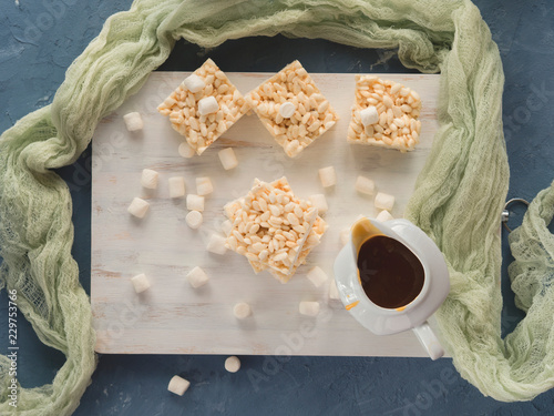 Puffed rice and marshmallow bars with caramel sauce. Top view photo