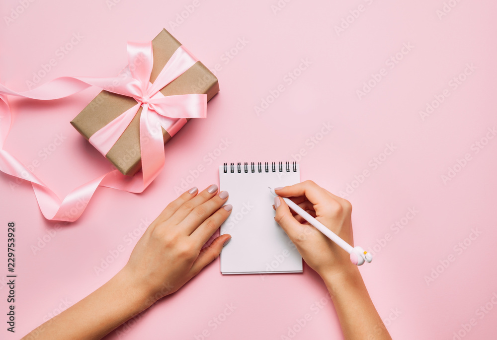 Beautiful female hands with trendy manicure writing in notebook Beautiful female hands with trendy manicure writing in notebook