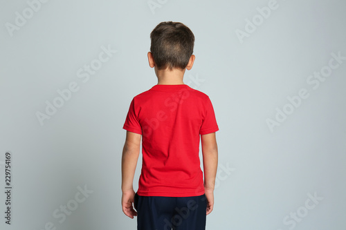 Little boy in t-shirt on gr...