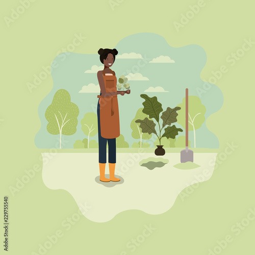 black woman planting tree in the park