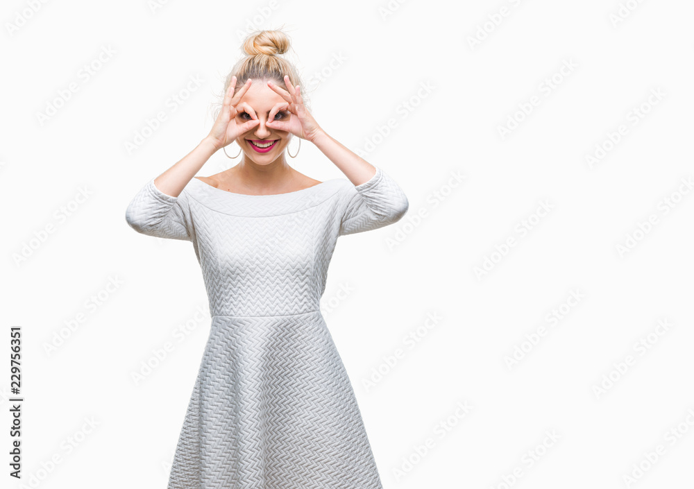 Young beautiful blonde and blue eyes woman over isolated background doing ok gesture like binoculars sticking tongue out, eyes looking through fingers. Crazy expression. Young beautiful blonde and blue eyes woman over isolated background doing ok gesture like binoculars sticking tongue out, eyes looking through fingers. Crazy expression.