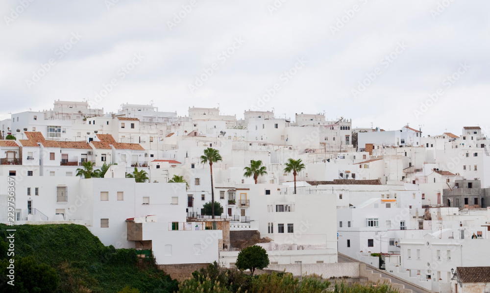 Architectural complex consisting of white houses next to each other on top of a mountain
