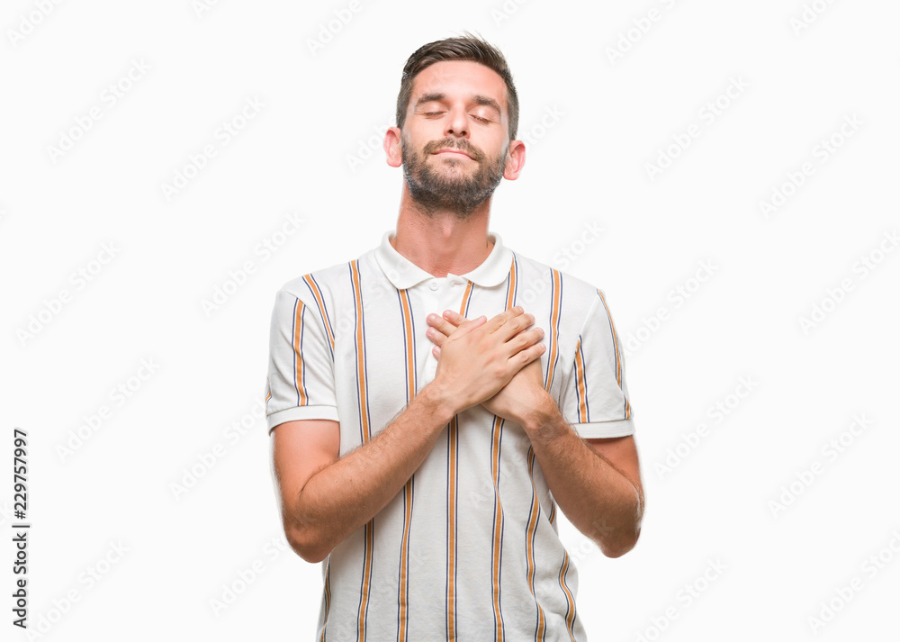 Young handsome man over isolated background smiling with hands on chest with closed eyes and grateful gesture on face. Health concept. Young handsome man over isolated background smiling with hands on chest with closed eyes and grateful gesture on face. Health concept.