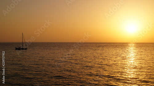 Sunset over Pacific Carribean beach showing dramatic red and yellow sky as sun sets  © Pluto119