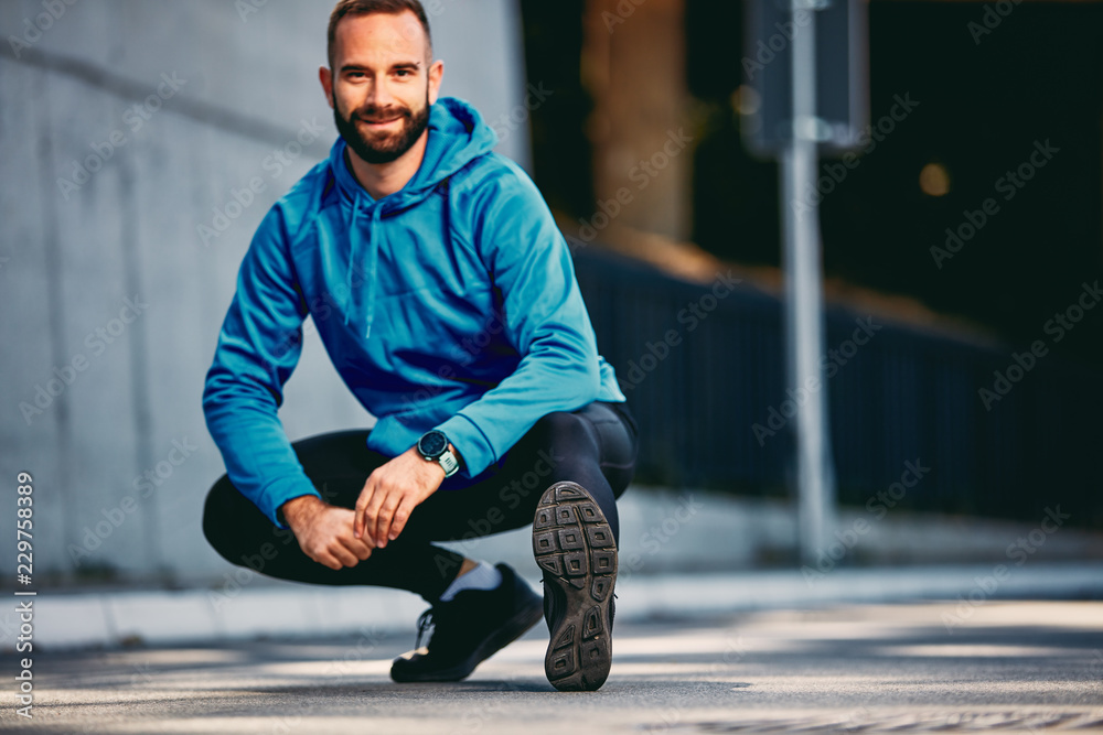 Bearded man stretching before running marathon. Healthy lifestyle concept. Bearded man stretching before running marathon. Healthy lifestyle concept.