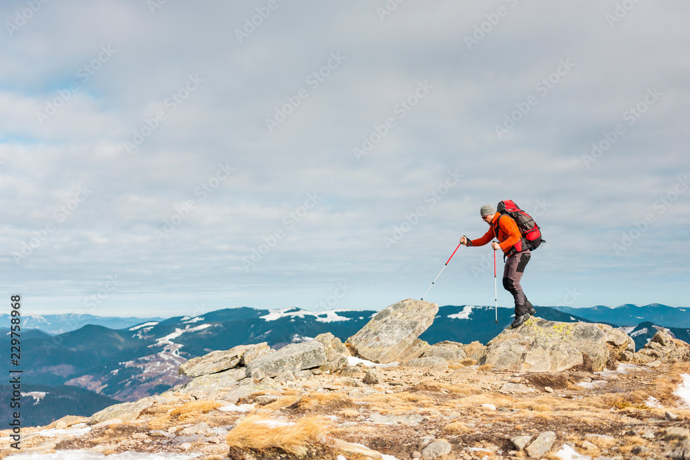 The climber on the top of the mountain.