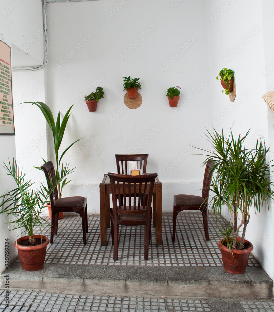 Andalusian patio with tables and four chairs wood