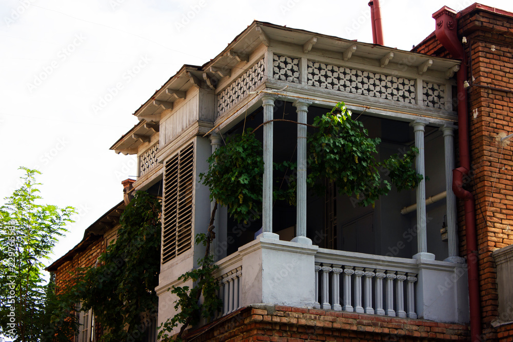 Old Tbilisi architecture, windows and balcony exterior decor in summer day