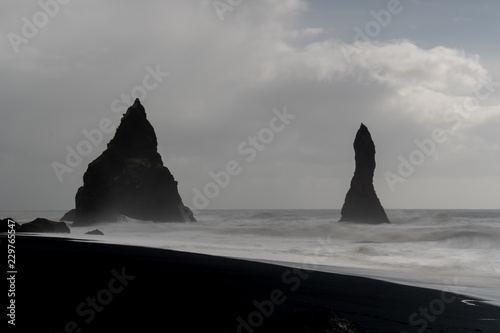 Rocks Reynisdrangar near Vik on a sunny day - Iceland