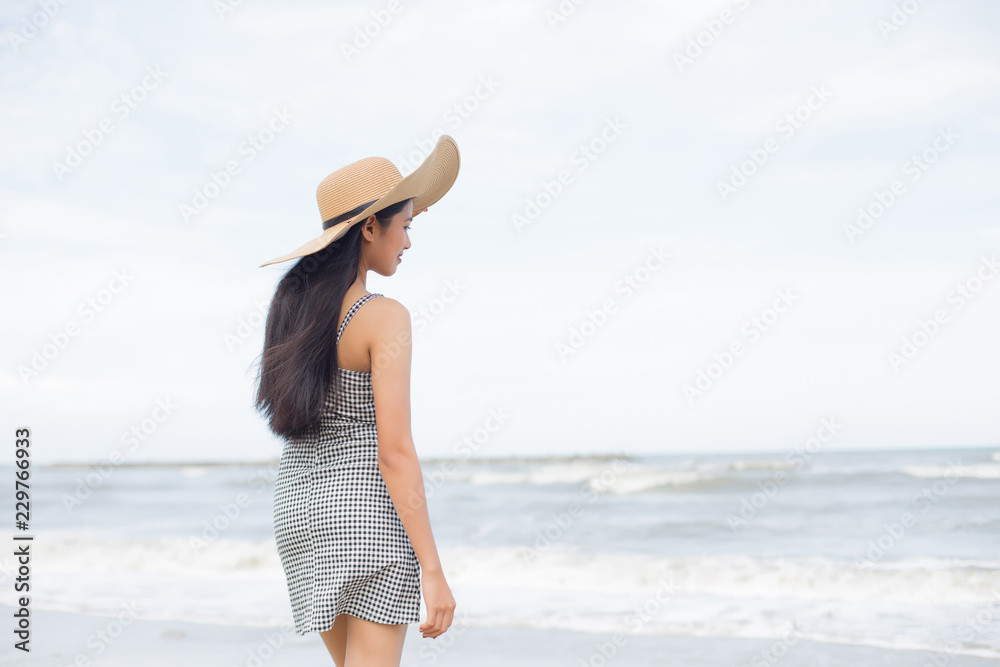 young pretty asian woman enjoy her freedom on the tropical beach