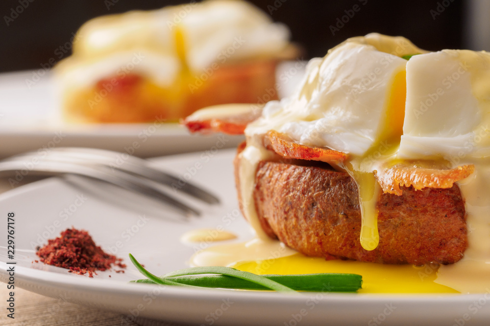 Breakfast is Eggs Benedict - toasted English muffins, bacon, ham, poached eggs, herbs and delicious buttery hollandaise sauce. Breakfast is Eggs Benedict - toasted English muffins, bacon, ham, poached eggs, herbs and delicious buttery hollandaise sauce.