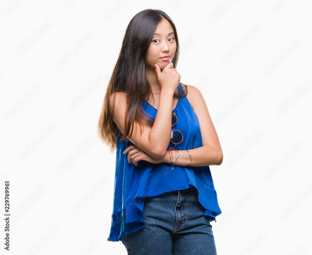 Young asian woman over isolated background looking confident at the camera with smile with crossed arms and hand raised on chin. Thinking positive. Young asian woman over isolated background looking confident at the camera with smile with crossed arms and hand raised on chin. Thinking positive.