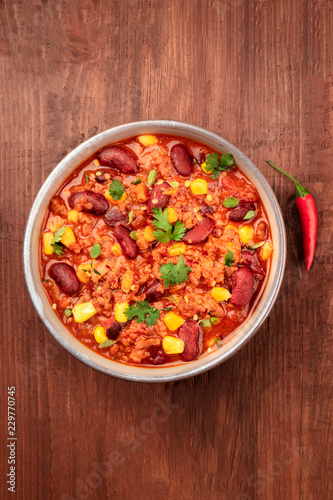Chili con carne, traditional Mexican dish, with a chili pepper, shot from the top with a place for text