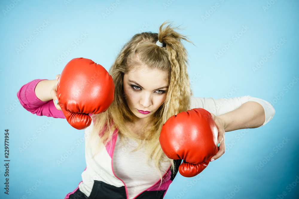 Funny woman wearing boxing gloves