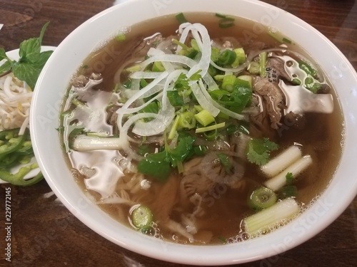 Vietnamese beef soup with basil and onions