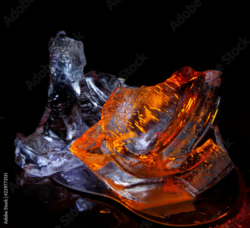 Pieces of ice painted by light on a black background..Still life, abstraction, background, texture