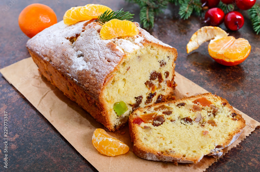 Christmas cake with nuts, dried fruit, tangerines. Traditional festive pastries.