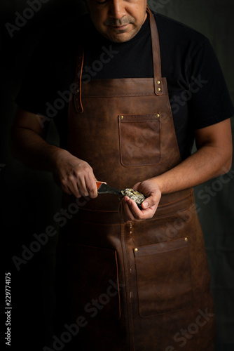 Man opening oyster