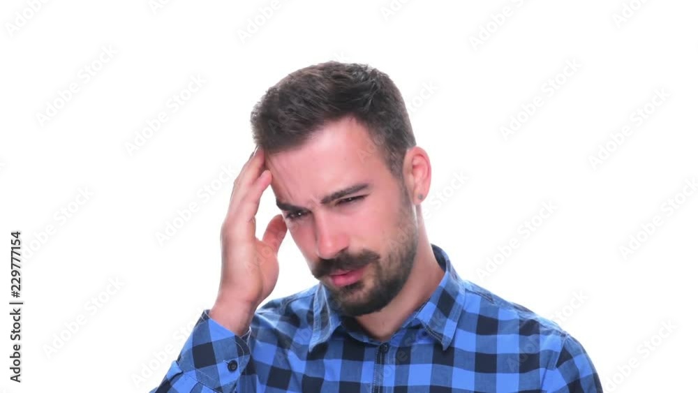 Young bearded man having a headache pain symptoms touching and massaging isolated on white background. Young bearded man having a headache pain symptoms touching and massaging isolated on white background.