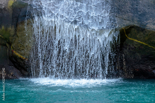 Waterfall in Tracy Arm fjord near Juneau Alaska photo