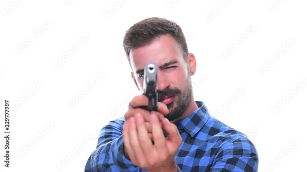 Young bearded man cocking gun aiming and shooting with pistol isolated on white background. Young bearded man cocking gun aiming and shooting with pistol isolated on white background.