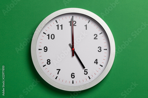clock shows five o'clock photo