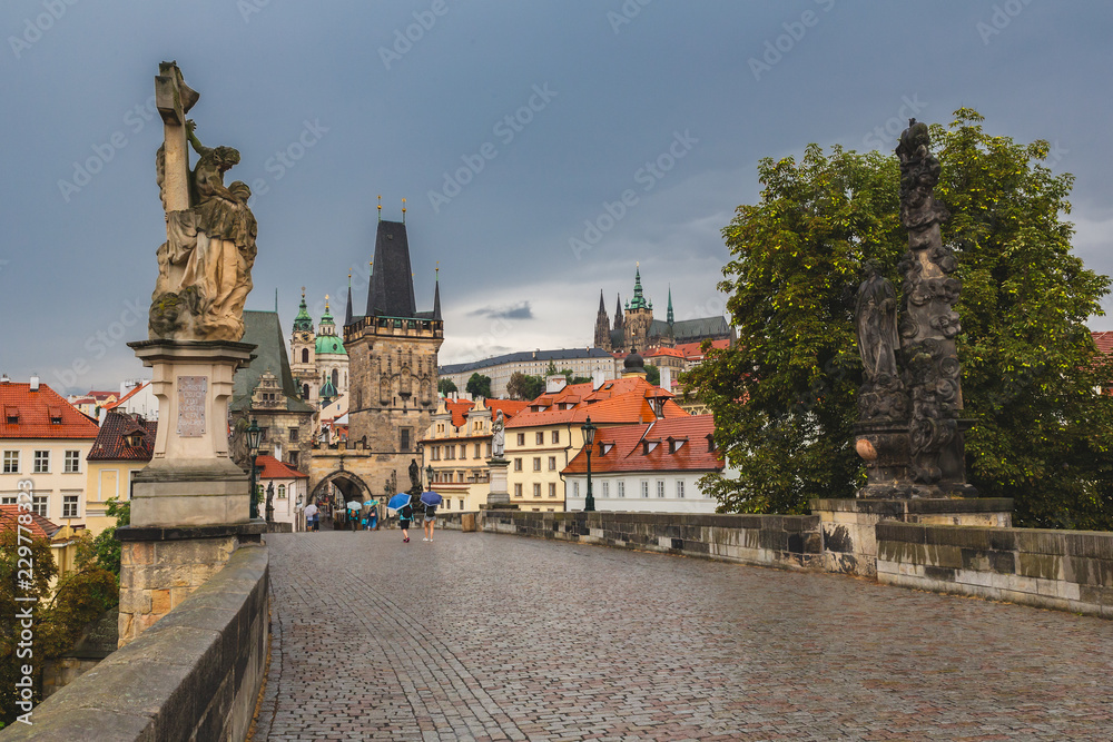 Rainy day view over Charles bridge in Prague. Perfect day for umbrella sightseeing