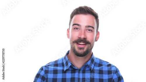 Young happy relaxed bearded hipster male vlogger talking to camera isolated on white background. 