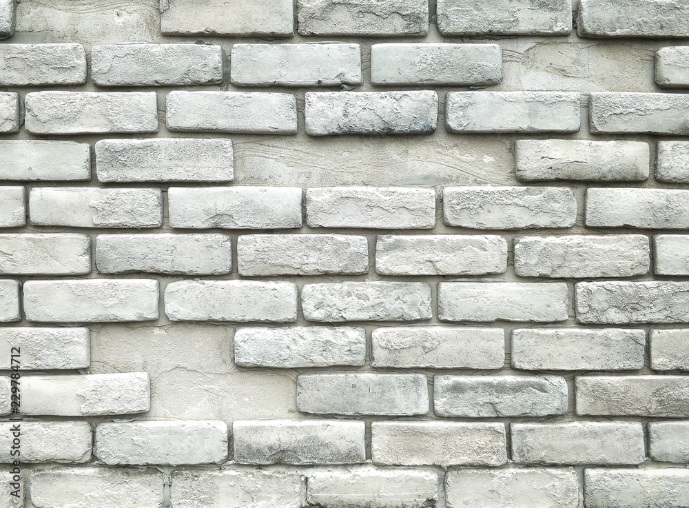The old bricks stone wall pattern with gray color painted in vintage style on brickwork exterior decoration design concept The old bricks stone wall pattern with gray color painted in vintage style on brickwork exterior decoration design concept