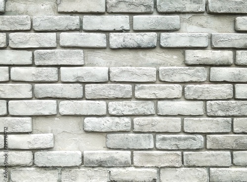 The old bricks stone wall pattern with gray color painted in vintage style on brickwork exterior decoration design concept