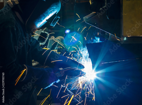 Worker welding the steel part by manua