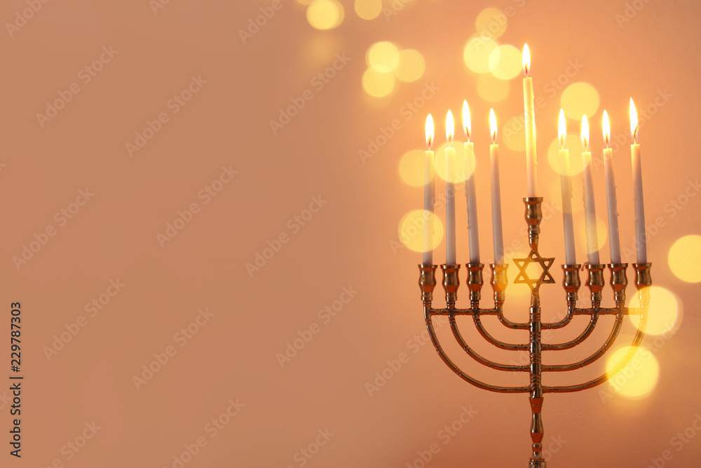 image of jewish holiday Hanukkah background with menorah (traditional candelabra) and candles.