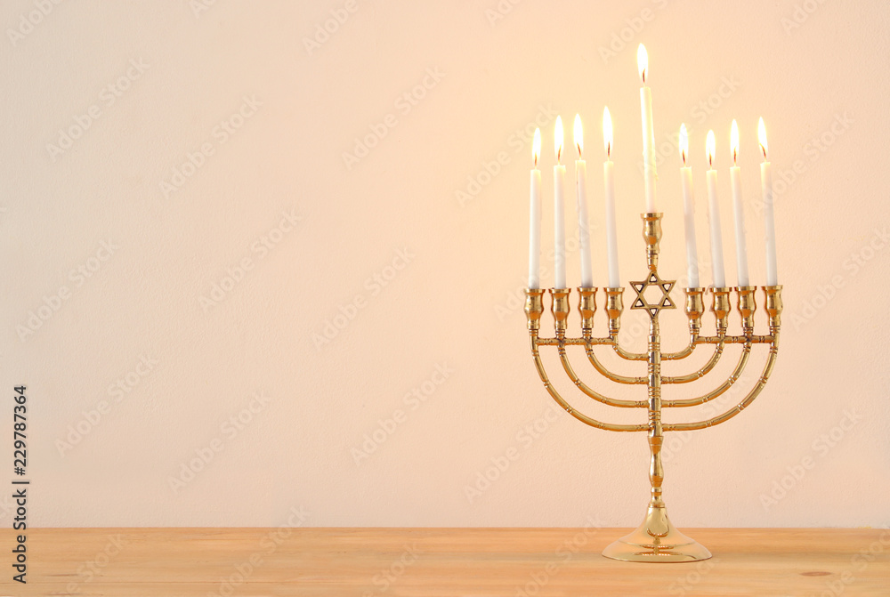 image of jewish holiday Hanukkah background with menorah (traditional candelabra) and candles. image of jewish holiday Hanukkah background with menorah (traditional candelabra) and candles.