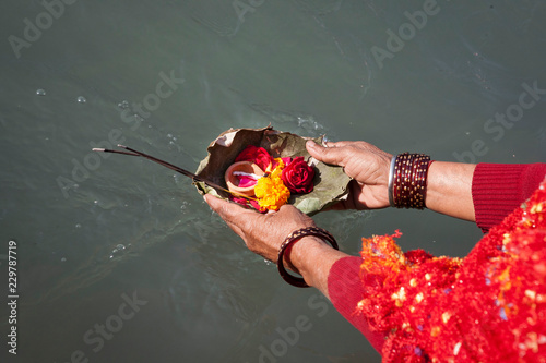 Woman performing offerings in the Ganges during the 2010 Kumbh Mela or Kumbha Mela Pilgrimage Celebration, Haridwar, Uttarkhand State, India photo