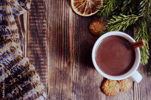 Fototapeta Naklejka Na Ścianę i Meble -  Hot chocolate or cocoa with cinnamon stick in a cup and fir branches. Winter hot drink for cold weather. New year and Christmas concept Top view
