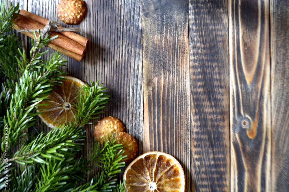 Christmas and new year background frame or postcard Christmas composition with fir branches dried oranges cookies cinnamon sticks and a scarf on a wooden background Christmas and new year background frame or postcard Christmas composition with fir branches dried oranges cookies cinnamon sticks and a scarf on a wooden background