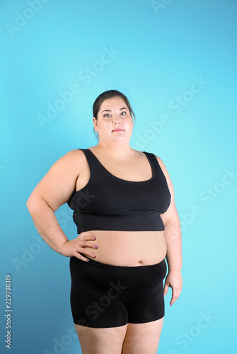 Overweight woman before weight loss on color background