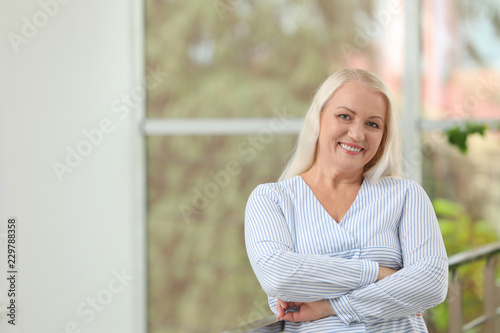 Portrait of beautiful older woman against blurred background with space for text © New Africa