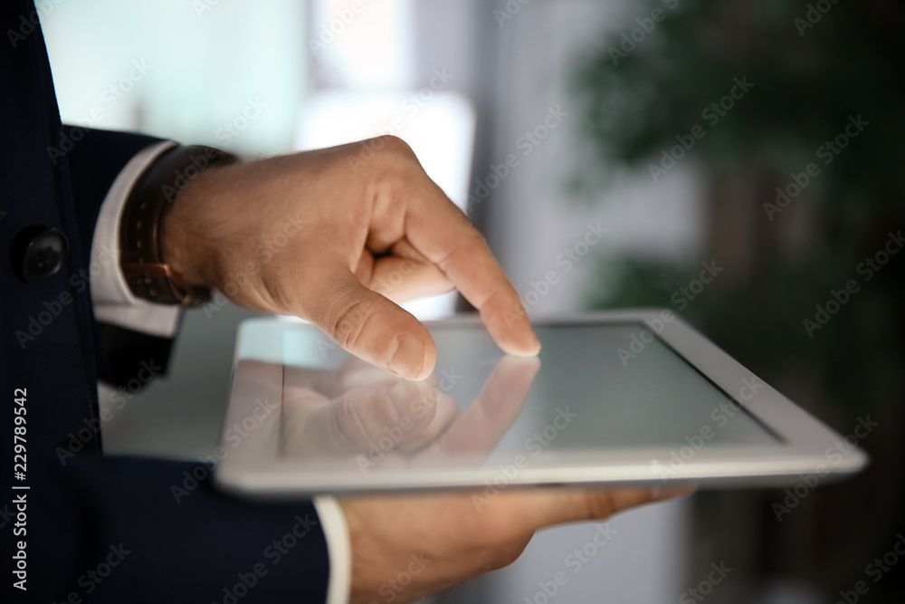 Businessman using digital tablet at workplace, closeup of hand. Mockup for design Businessman using digital tablet at workplace, closeup of hand. Mockup for design