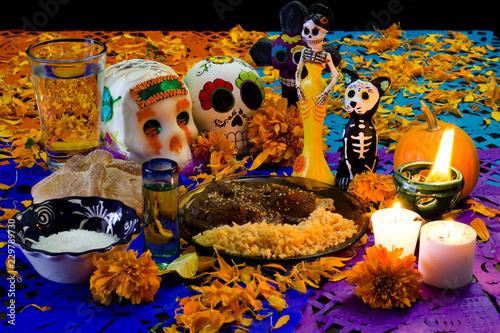 Ofrenda de día de muertos. Con calavera de azúcar, pan de muerto y platillo tradicional mexicano 2 photo