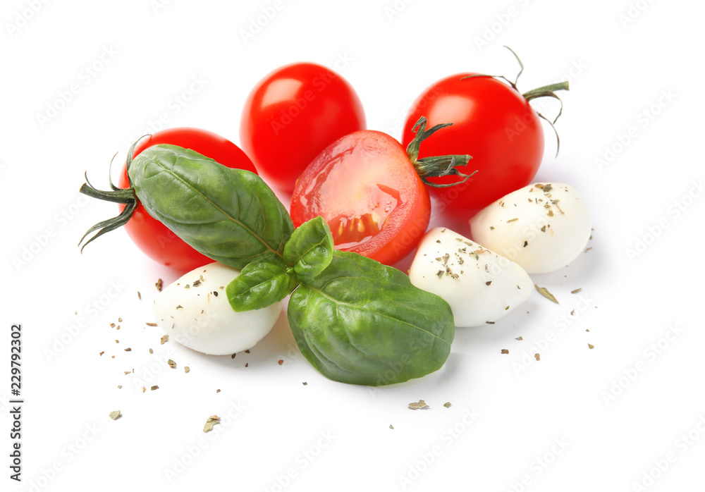 Fresh green basil leaves, cherry tomatoes and mozzarella on white background