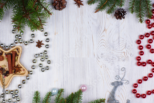 New Year's frame with shiny beads, a deer and decorated with fir branches