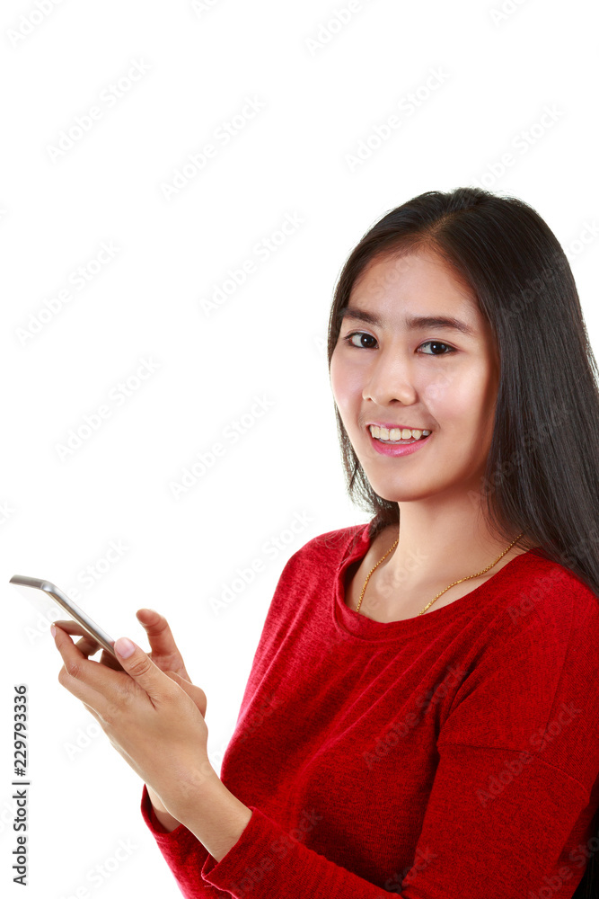 Young Asian woman holding mobile phone and taking note with smiling to camera on white background with clipping path Young Asian woman holding mobile phone and taking note with smiling to camera on white background with clipping path