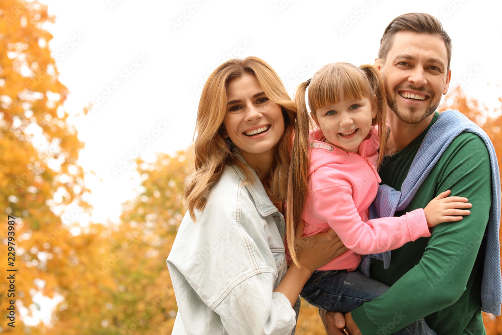 Happy family with child together in park. Autumn walk Happy family with child together in park. Autumn walk