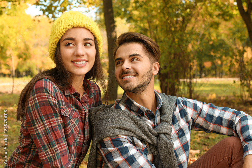 Fototapeta premium Young lovely couple spending time together in park. Autumn walk