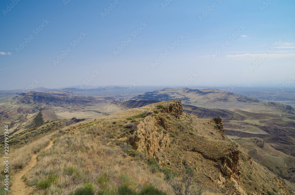At the edge of cliff. Stunning view from footpath on the rock edge, on the half-desert slopes of Mount Gareja. David Gareja. Georgia, Kakheti region, on border of Georgia and Azerbaijan