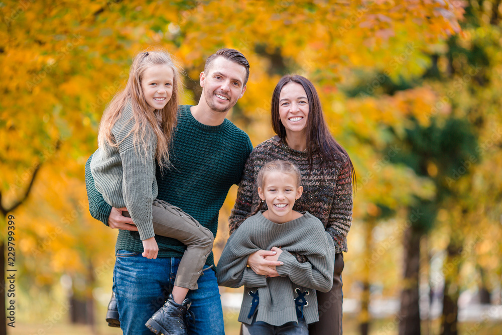 Portrait of happy family of four in autumn