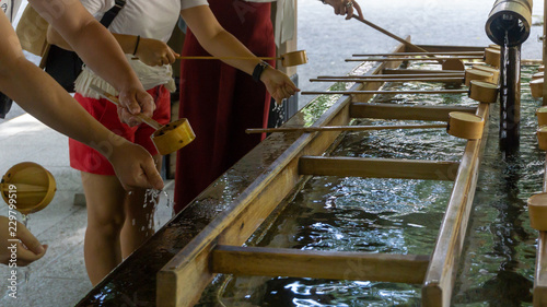 Hands of unidentified people during ritual cleansing in Temizuya or Chozuya at Meiji Shrine located in Shibuya,Tokyo